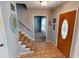 Entryway with tiled floor, stairs, and view to living room at 6031 S Eaton Ave, Indianapolis, IN 46259