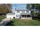 Two-story house with gray siding, blue shutters, and a covered porch at 6031 S Eaton Ave, Indianapolis, IN 46259
