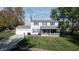 Two-story house with gray roof, white siding, and blue shutters at 6031 S Eaton Ave, Indianapolis, IN 46259