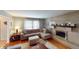 Living room with fireplace, sectional sofa, and hardwood floors at 6031 S Eaton Ave, Indianapolis, IN 46259