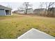 Large backyard with grassy area and patio, offering ample outdoor space at 6329 Basden Dr, Indianapolis, IN 46221