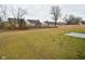Spacious backyard with a large grassy area and a concrete patio at 6329 Basden Dr, Indianapolis, IN 46221