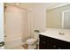 Bathroom boasts a shower/tub combo, vanity, and dark brown cabinets at 6329 Basden Dr, Indianapolis, IN 46221