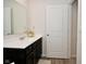 Modern bathroom with dark brown vanity and a large mirror at 6329 Basden Dr, Indianapolis, IN 46221