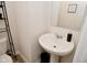 Small bathroom with pedestal sink and simple decor at 6329 Basden Dr, Indianapolis, IN 46221