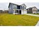 Two-story house with navy blue siding, white garage door, and a well-maintained lawn at 6329 Basden Dr, Indianapolis, IN 46221