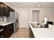 Modern kitchen with dark brown cabinets, stainless steel appliances, and tile backsplash at 6329 Basden Dr, Indianapolis, IN 46221