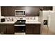 Modern kitchen with dark wood cabinets and stainless steel appliances at 6329 Basden Dr, Indianapolis, IN 46221