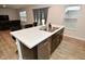 Kitchen island with double sink, stainless steel dishwasher, and white countertop at 6329 Basden Dr, Indianapolis, IN 46221