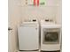 Laundry room with LG washer and dryer, and overhead shelving at 6329 Basden Dr, Indianapolis, IN 46221