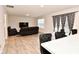 Open concept living room with black leather furniture and kitchen view at 6329 Basden Dr, Indianapolis, IN 46221