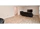 Living room with black leather sectional sofa and stairs leading upstairs at 6329 Basden Dr, Indianapolis, IN 46221