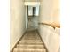 Basement stairs with carpeted steps and wooden railing at 8429 Admirals Cv, Indianapolis, IN 46236