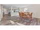 Bright dining area with wooden table and chairs, open to living area at 9549 W Quarter Moon Dr, Pendleton, IN 46064