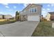 Two-story house with gray siding, attached garage, and long driveway at 9549 W Quarter Moon Dr, Pendleton, IN 46064