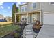 Inviting front porch with stone walkway, and cozy seating area at 9549 W Quarter Moon Dr, Pendleton, IN 46064