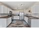 Modern kitchen with white cabinets, stainless steel appliances and tile floor at 9549 W Quarter Moon Dr, Pendleton, IN 46064