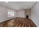 Living room features hardwood floors and a corner stone fireplace at 111 Independence Ave, Anderson, IN 46012