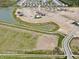 Aerial view of Meadows at Belleview community with new homes and pond at 1366 School Bell Dr, Greenwood, IN 46143