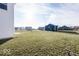 Spacious backyard with grassy area and views of neighboring homes at 2400 Oakmont Dr, Plainfield, IN 46168