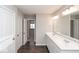 Double vanity bathroom with white cabinets and a large mirror at 2400 Oakmont Dr, Plainfield, IN 46168