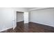 Well-lit bedroom with hardwood floors and an open door to another room at 2400 Oakmont Dr, Plainfield, IN 46168