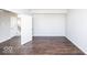 Spacious bedroom with dark hardwood floors and neutral walls at 2400 Oakmont Dr, Plainfield, IN 46168