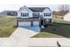 Two-story house with white siding, brick accents, and a three-car garage at 2400 Oakmont Dr, Plainfield, IN 46168