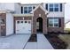 Two-story house with white siding and brick accents, featuring a white garage door at 2400 Oakmont Dr, Plainfield, IN 46168