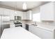 Modern kitchen with island, stainless steel appliances and hardwood floors at 2400 Oakmont Dr, Plainfield, IN 46168