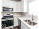 Modern kitchen with stainless steel appliances and white cabinets at 2400 Oakmont Dr, Plainfield, IN 46168