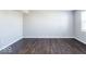 Spacious living room featuring dark hardwood floors and neutral walls at 2400 Oakmont Dr, Plainfield, IN 46168