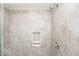Shower with gray tile, built-in shelves, and a modern shower head at 2400 Oakmont Dr, Plainfield, IN 46168