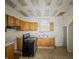 Kitchen featuring wood cabinets and a gas stove at 2439 N Kenwood Ave, Indianapolis, IN 46208