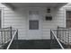 White front door with glass window and black railings at 3525 N Olney St, Indianapolis, IN 46218