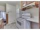 White appliances and wood cabinets in this kitchen at 3525 N Olney St, Indianapolis, IN 46218