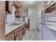 Kitchen with white appliances and wood cabinets at 3525 N Olney St, Indianapolis, IN 46218