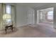 Empty living room with pink carpet, lamp, and view to dining room at 3525 N Olney St, Indianapolis, IN 46218