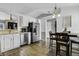 Kitchen with white cabinets, stainless steel appliances, and dining area at 3917 St Simons Ct, Indianapolis, IN 46237