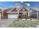 Brick and shingle two-story home with a covered porch and two-car garage at 3923 Holly Brook Dr, Westfield, IN 46062