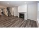 Open Gathering room with hardwood floors, fireplace and view of the staircase at 3923 Holly Brook Dr, Westfield, IN 46062