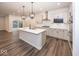 Modern kitchen features an island, stainless steel appliances, white cabinets and hardwood floors at 3923 Holly Brook Dr, Westfield, IN 46062