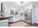 Modern kitchen with white cabinets, stainless steel appliances, and quartz countertops at 413 E Caven St, Indianapolis, IN 46225