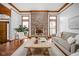 Living room with a brick fireplace and hardwood floors at 4564 Bayberry Ln, Zionsville, IN 46077