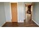 Bedroom with gray walls, wood-look floors and door to another room at 4726 E 210 N, Lebanon, IN 46052