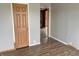 Bedroom with gray walls, wood-look floors and door to another room at 4726 E 210 N, Lebanon, IN 46052