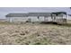 Back of house showing siding, deck, and adjacent field at 4726 E 210 N, Lebanon, IN 46052