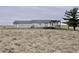 Back of house showing siding, deck, and adjacent field at 4726 E 210 N, Lebanon, IN 46052