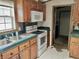 Kitchen with wood cabinets, teal countertops, and appliances at 4726 E 210 N, Lebanon, IN 46052