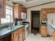 Kitchen with wood cabinets, white appliances, and green tile at 4726 E 210 N, Lebanon, IN 46052